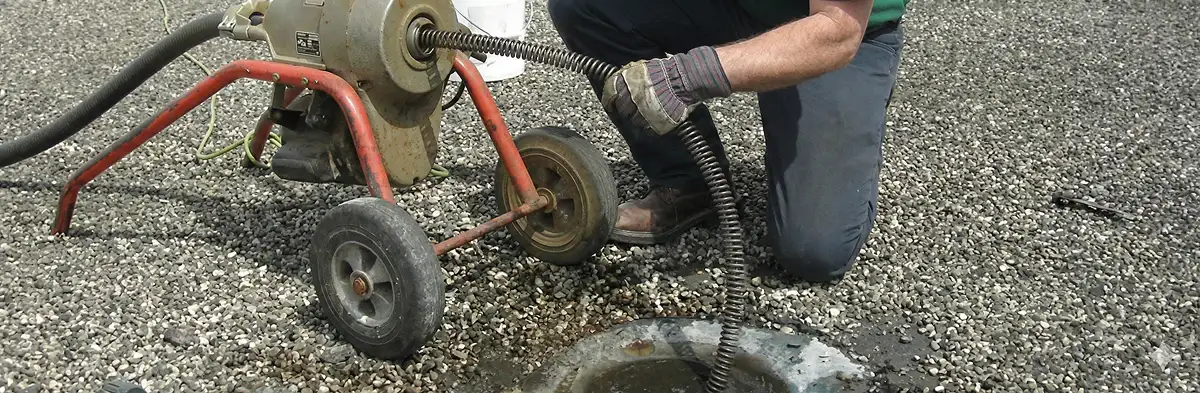 sewer rodding technician actively removing blockages from a sewer line in Bellevue, WA